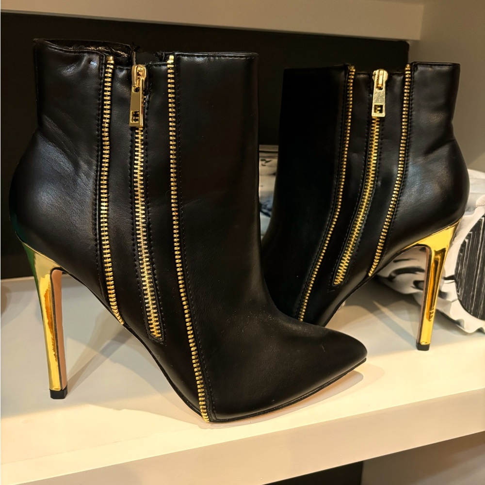 Black and gold woman’s shoes